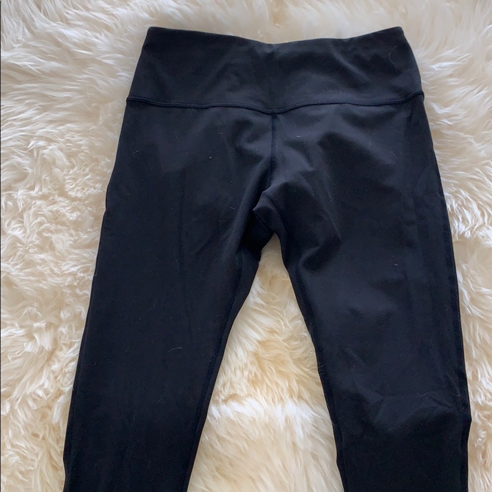 Black high-rise leggings with crisscross detail